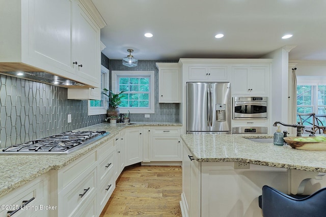 801 Shady Ln, Anchorage, KY 40223 - kitchen with stainless steel appliances, white cabinetry, light wood finished floors, tasteful backsplash, and recessed lighting