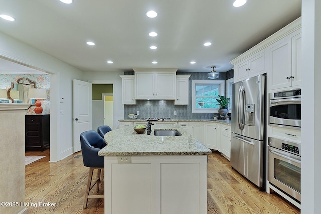801 Shady Ln, Anchorage, KY 40223 - kitchen with stainless steel refrigerator with ice dispenser, a sink, white cabinets, a center island with sink, and light wood-style flooring