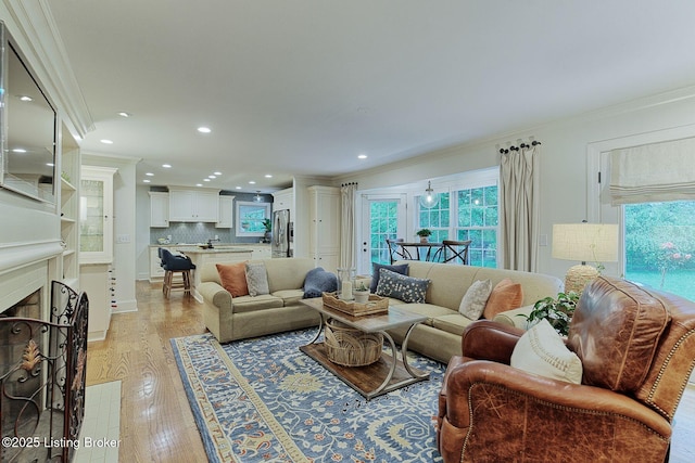 801 Shady Ln, Anchorage, KY 40223 - living room with ornamental molding, light wood-style flooring, recessed lighting, and a fireplace