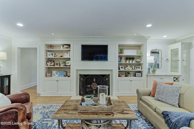 801 Shady Ln, Anchorage, KY 40223 - living room with crown molding, recessed lighting, light wood-style flooring, a fireplace with flush hearth, and built in shelves