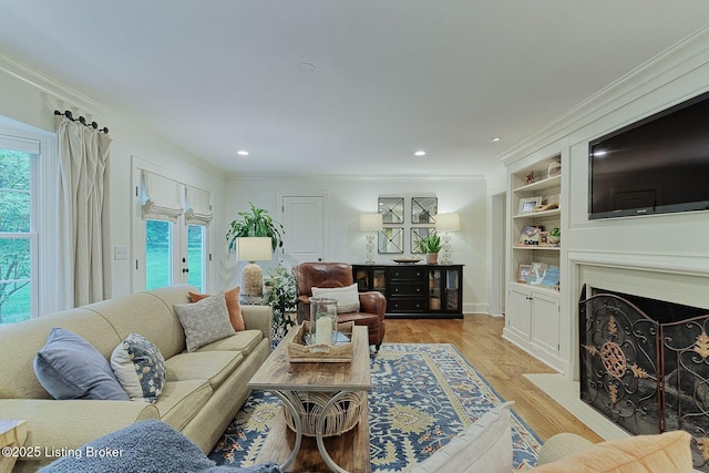 801 Shady Ln, Anchorage, KY 40223 - living area featuring ornamental molding, light wood-type flooring, recessed lighting, and a fireplace with flush hearth
