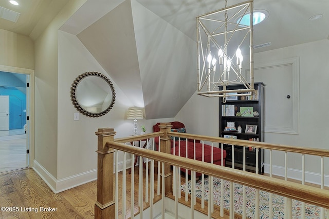 801 Shady Ln, Anchorage, KY 40223 - staircase featuring wood finished floors, a chandelier, baseboards, and lofted ceiling