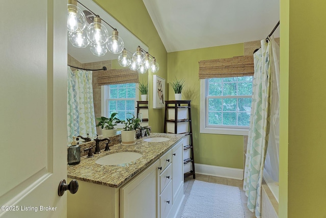 801 Shady Ln, Anchorage, KY 40223 - full bathroom featuring vaulted ceiling, double vanity, tile patterned flooring, baseboards, and curtained shower