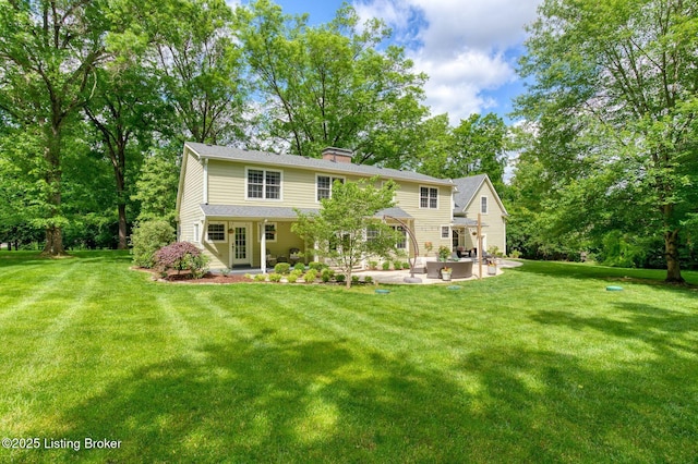 801 Shady Ln, Anchorage, KY 40223 - back of house featuring a patio area, a lawn, and a chimney