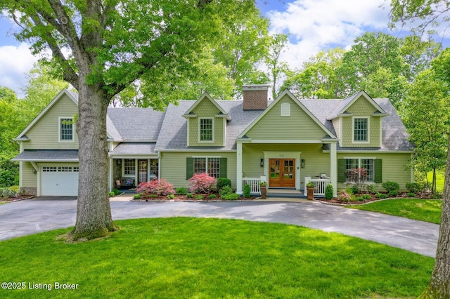 801 Shady Ln, Anchorage, KY 40223 - view of front facade featuring driveway, french doors, a chimney, a front yard, and roof with shingles