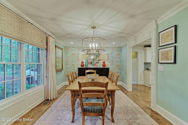 801 Shady Ln, Anchorage, KY 40223 - dining area featuring a chandelier, healthy amount of natural light, crown molding, wood finished floors, and wallpapered walls