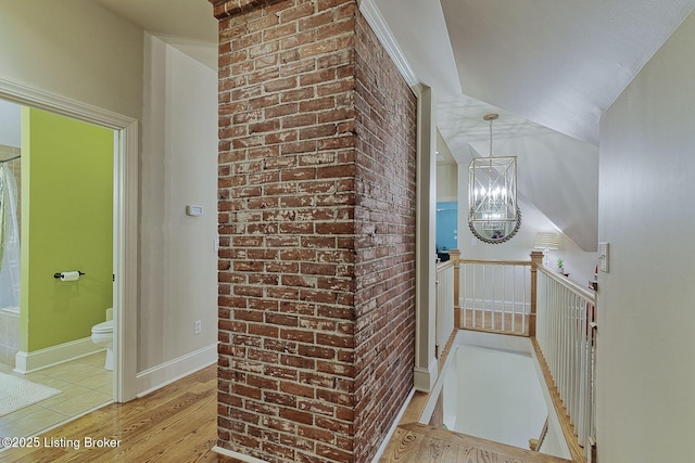 801 Shady Ln, Anchorage, KY 40223 - hallway featuring an upstairs landing, light wood-style flooring, and a chandelier