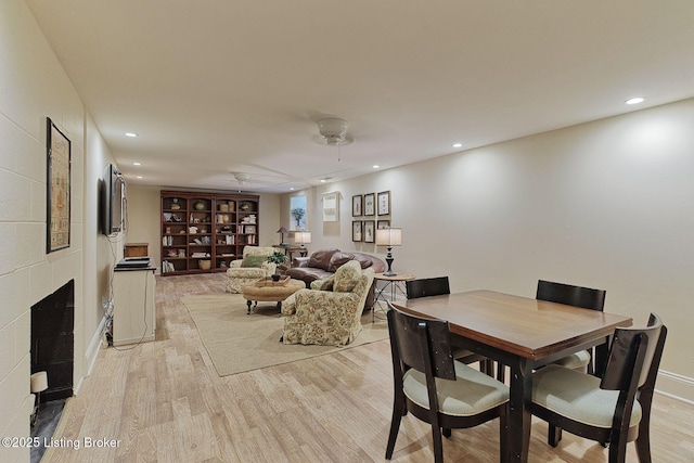 801 Shady Ln, Anchorage, KY 40223 - dining area featuring light wood-style flooring, recessed lighting, a large fireplace, and baseboards