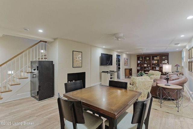 801 Shady Ln, Anchorage, KY 40223 - dining area with light wood finished floors, stairway, recessed lighting, baseboards, and a fireplace