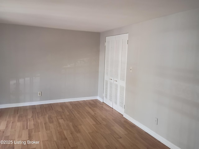 1244 Belmar Dr, Louisville, KY 40213 - unfurnished bedroom featuring wood finished floors, a closet, and baseboards