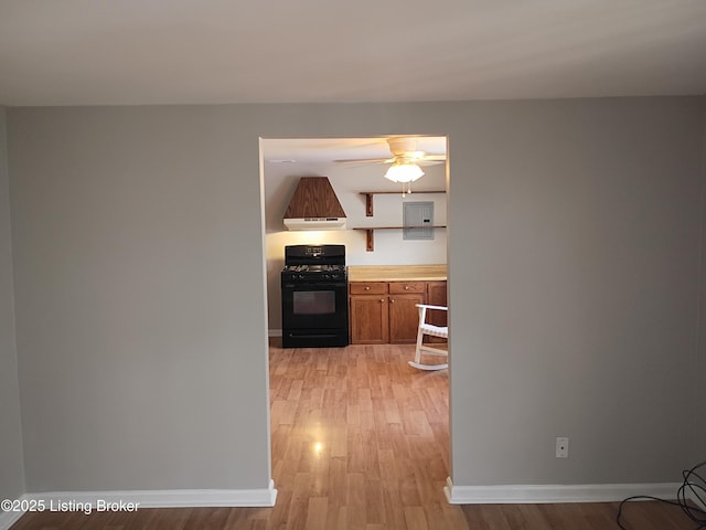 1244 Belmar Dr, Louisville, KY 40213 - kitchen featuring black gas range, light wood-style flooring, baseboards, brown cabinetry, and custom exhaust hood