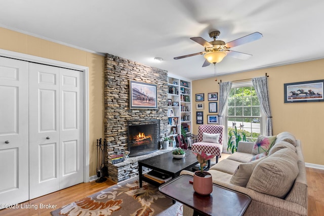 3711 Quail Hollow Ct, Louisville, KY 40241 - living area featuring light wood finished floors, ceiling fan, a stone fireplace, built in shelves, and crown molding