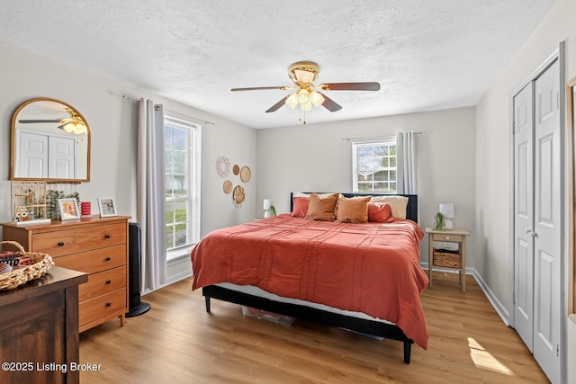 224 Murphy Ln, Bloomfield, KY 40008 - bedroom featuring a textured ceiling, light wood finished floors, a closet, and ceiling fan
