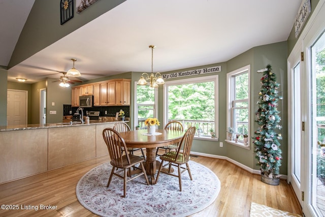 79 Ivy Ct, Brandenburg, KY 40108 - dining space with light wood-style flooring, baseboards, a chandelier, and a ceiling fan