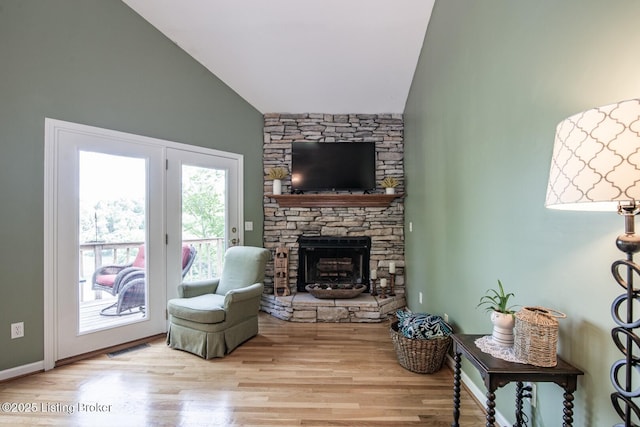 79 Ivy Ct, Brandenburg, KY 40108 - living area with wood finished floors, a stone fireplace, and high vaulted ceiling