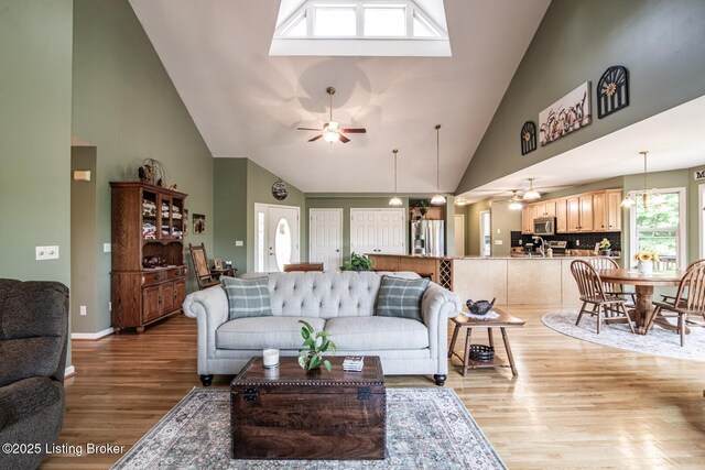 79 Ivy Ct, Brandenburg, KY 40108 - living area with a ceiling fan, high vaulted ceiling, light wood finished floors, and baseboards