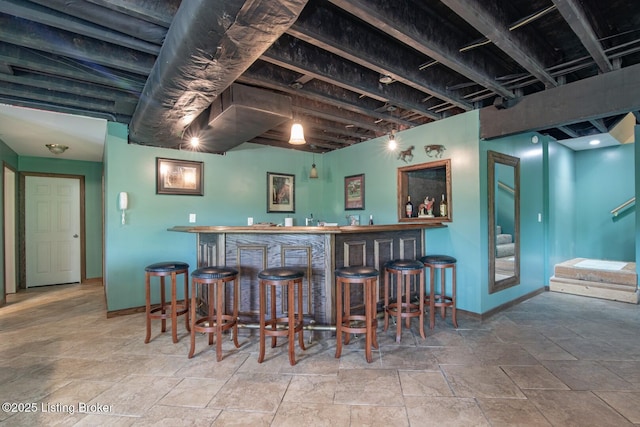 79 Ivy Ct, Brandenburg, KY 40108 - indoor wet bar featuring baseboards and stone tile floors