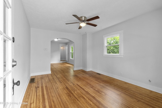 1011 Wetterau Ave, Louisville, KY 40217 - unfurnished room featuring arched walkways, ceiling fan, light wood finished floors, and baseboards
