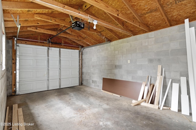 1011 Wetterau Ave, Louisville, KY 40217 - garage featuring a garage door opener and concrete block wall