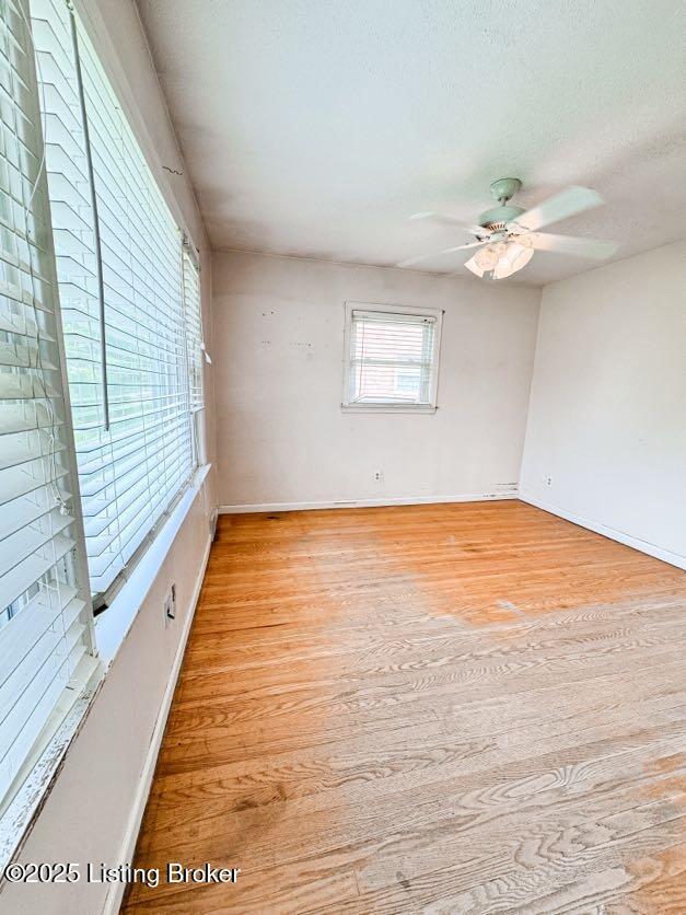 6302 Casper Dr, Louisville, KY 40258 - unfurnished room featuring light wood-type flooring, baseboards, ceiling fan, and a textured ceiling