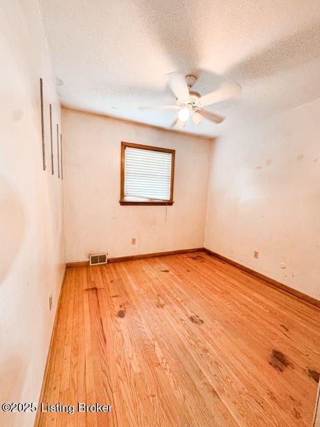6302 Casper Dr, Louisville, KY 40258 - unfurnished room featuring light wood-type flooring, a ceiling fan, a textured ceiling, and baseboards