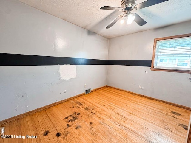 6302 Casper Dr, Louisville, KY 40258 - unfurnished room featuring a textured ceiling, hardwood / wood-style flooring, a ceiling fan, and baseboards