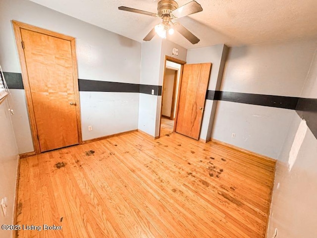 6302 Casper Dr, Louisville, KY 40258 - unfurnished bedroom with light wood finished floors, baseboards, a ceiling fan, and a textured ceiling
