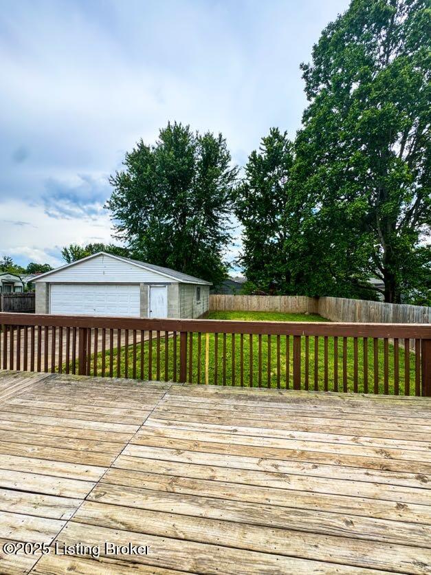 6302 Casper Dr, Louisville, KY 40258 - wooden deck featuring a garage, an outdoor structure, and a fenced backyard