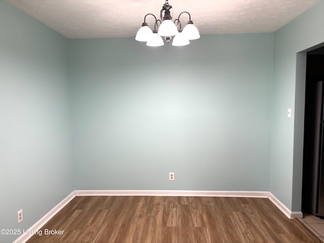 1513 La Fontenay Ct, Louisville, KY 40223 - spare room featuring wood finished floors, a chandelier, baseboards, and a textured ceiling