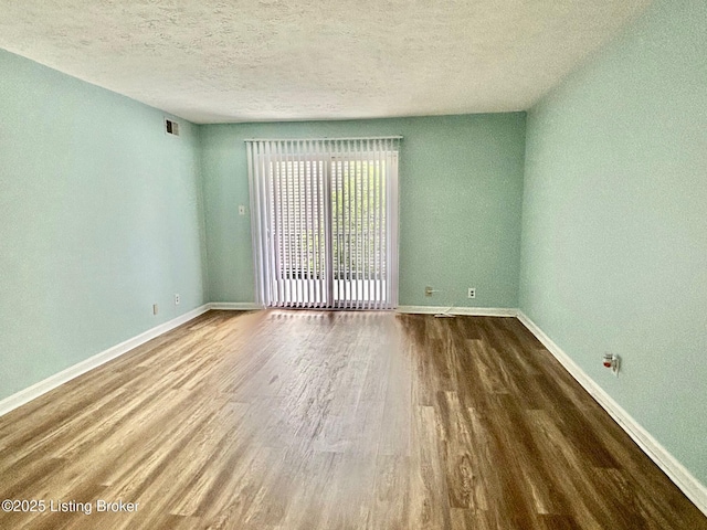 1513 La Fontenay Ct, Louisville, KY 40223 - empty room with wood finished floors, baseboards, and a textured ceiling