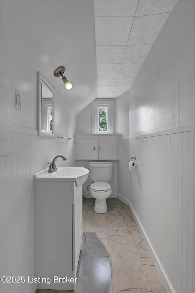 1433 Indiana Ave, Louisville, KY 40213 - half bathroom featuring wainscoting, toilet, marble finish floors, vanity, and lofted ceiling