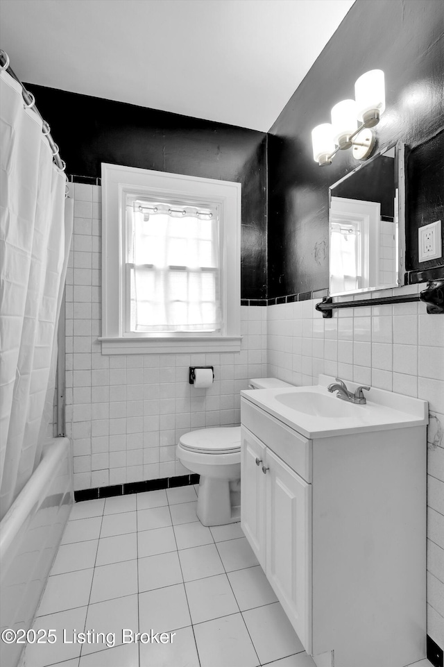 1433 Indiana Ave, Louisville, KY 40213 - bathroom featuring tile walls, tile patterned floors, toilet, vanity, and wainscoting