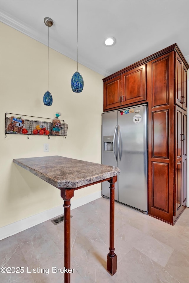 1433 Indiana Ave, Louisville, KY 40213 - kitchen with stainless steel fridge, dark countertops, pendant lighting, a peninsula, and recessed lighting