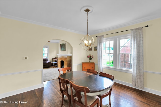 1433 Indiana Ave, Louisville, KY 40213 - dining room with arched walkways, dark wood-style floors, a fireplace, baseboards, and a chandelier