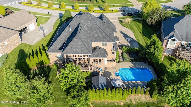 aerial view of property and surrounding area with a pool area