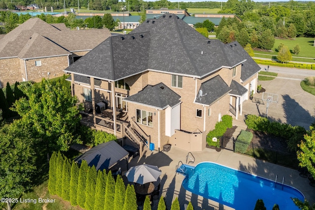 view of subject property featuring a pool area