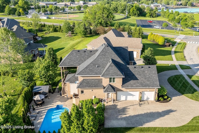 aerial view of property and surrounding area featuring a pool