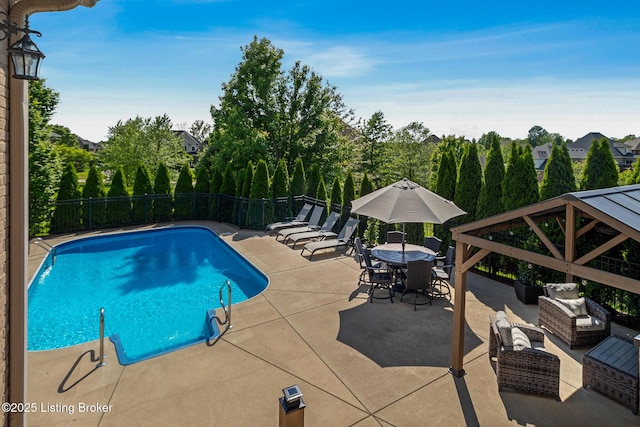 view of swimming pool featuring a patio, fence, outdoor lounge area, and a gazebo