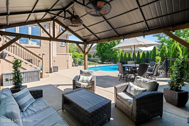 view of patio / terrace with an outdoor hangout area, fence, stairs, a ceiling fan, and outdoor dining area