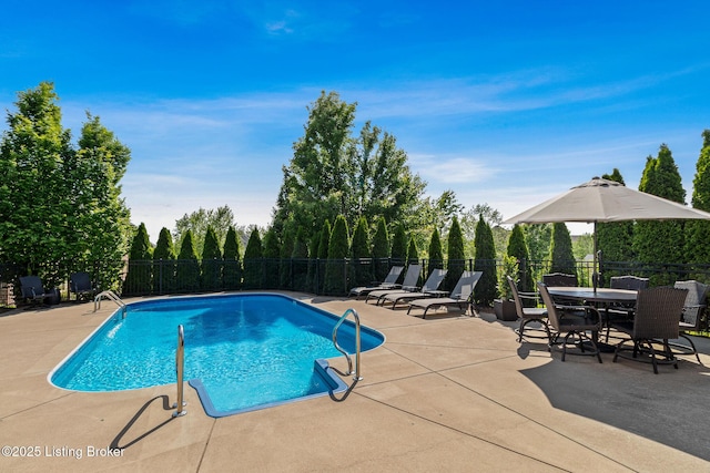 view of swimming pool with fence, a patio, and outdoor dining space