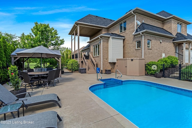 view of swimming pool featuring stairway, fence, and a patio area