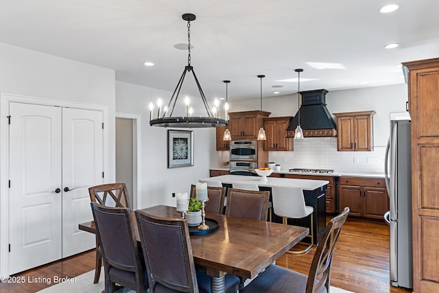 dining space with dark wood-style floors and recessed lighting
