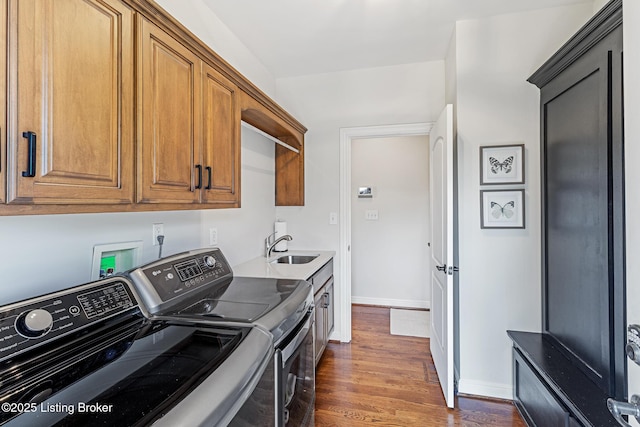 washroom with washer and dryer, cabinet space, dark wood-type flooring, and baseboards