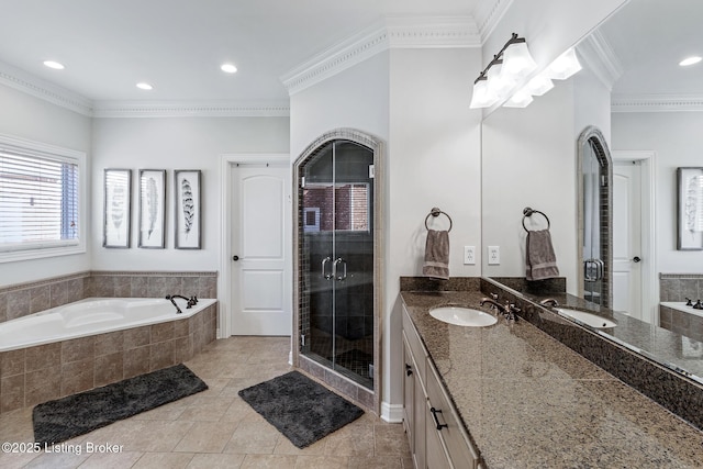 bathroom with a bath, crown molding, a shower stall, vanity, and recessed lighting