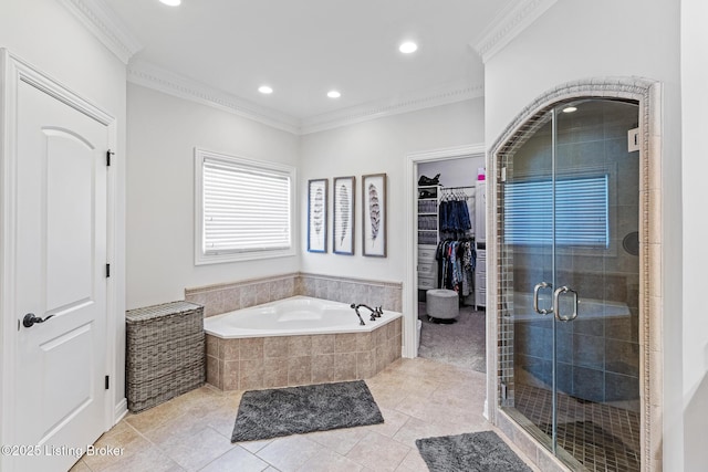 bathroom with a shower stall, crown molding, a spacious closet, tile patterned flooring, and a bath