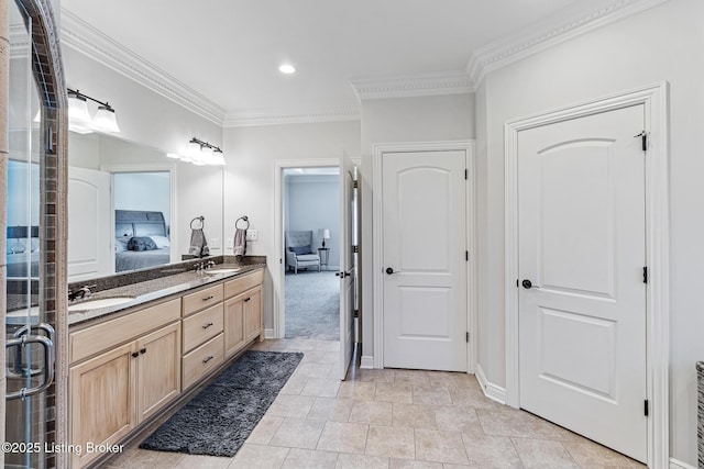 ensuite bathroom with crown molding, double vanity, recessed lighting, baseboards, and a shower with door