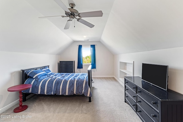 carpeted bedroom with baseboards, vaulted ceiling, and a ceiling fan