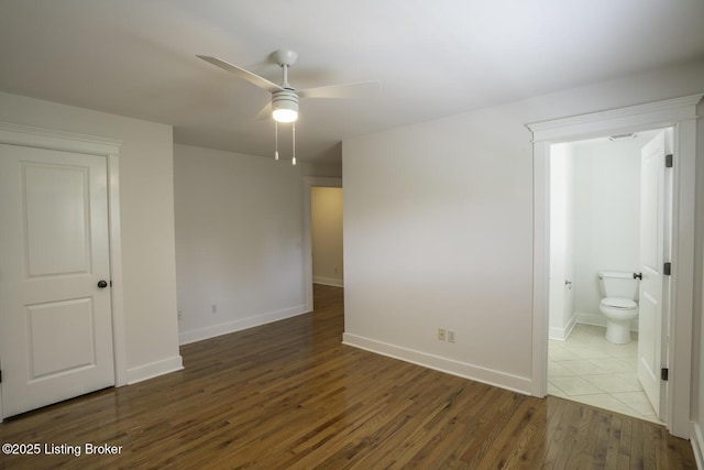 895 Woodlawn Rd Unit 2, Bardstown, KY 40004 - unfurnished bedroom featuring wood finished floors, baseboards, connected bathroom, and a ceiling fan