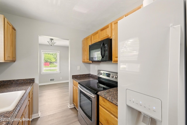 2410 Waco Ct, Louisville, KY 40216 - kitchen with black microwave, white refrigerator with ice dispenser, stainless steel range with electric stovetop, light wood-style floors, and a sink