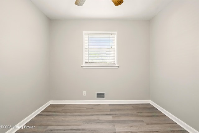 2410 Waco Ct, Louisville, KY 40216 - empty room with wood finished floors, a ceiling fan, and baseboards